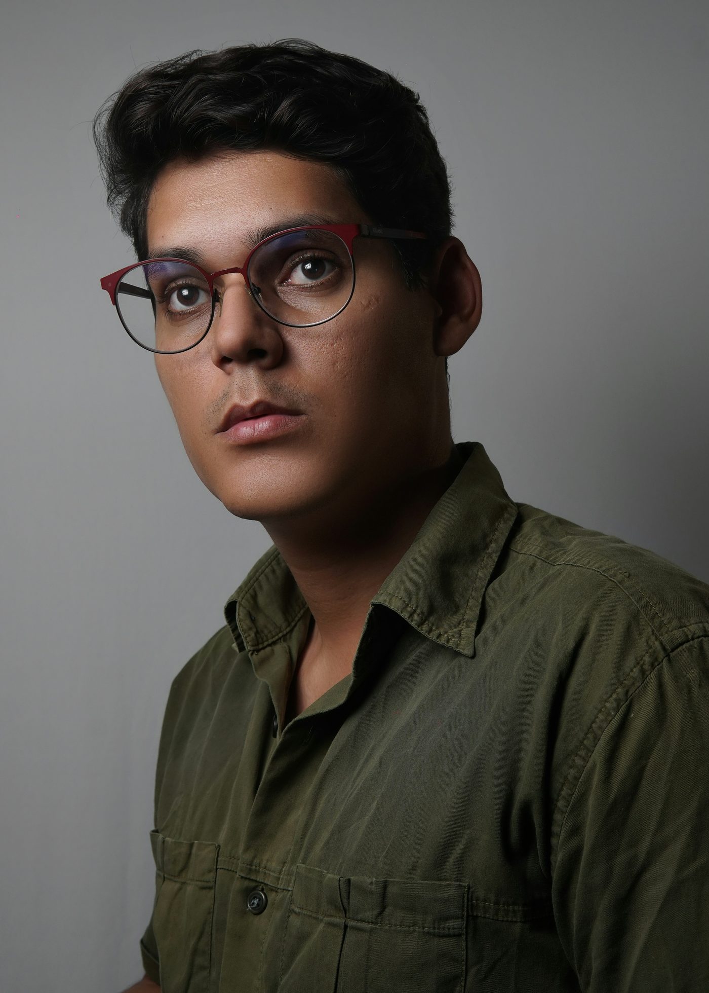 Man wearing red and black round glasses