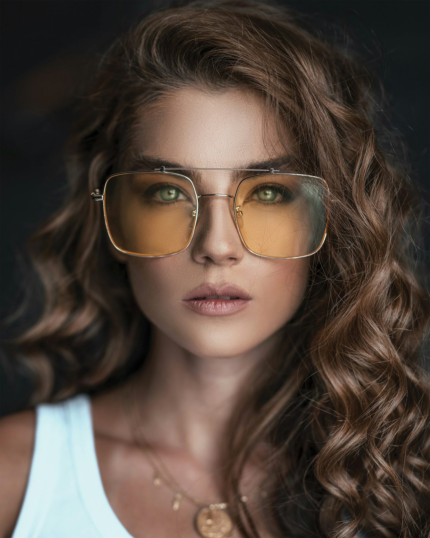Woman wearing amber-tinted aviator sunglasses