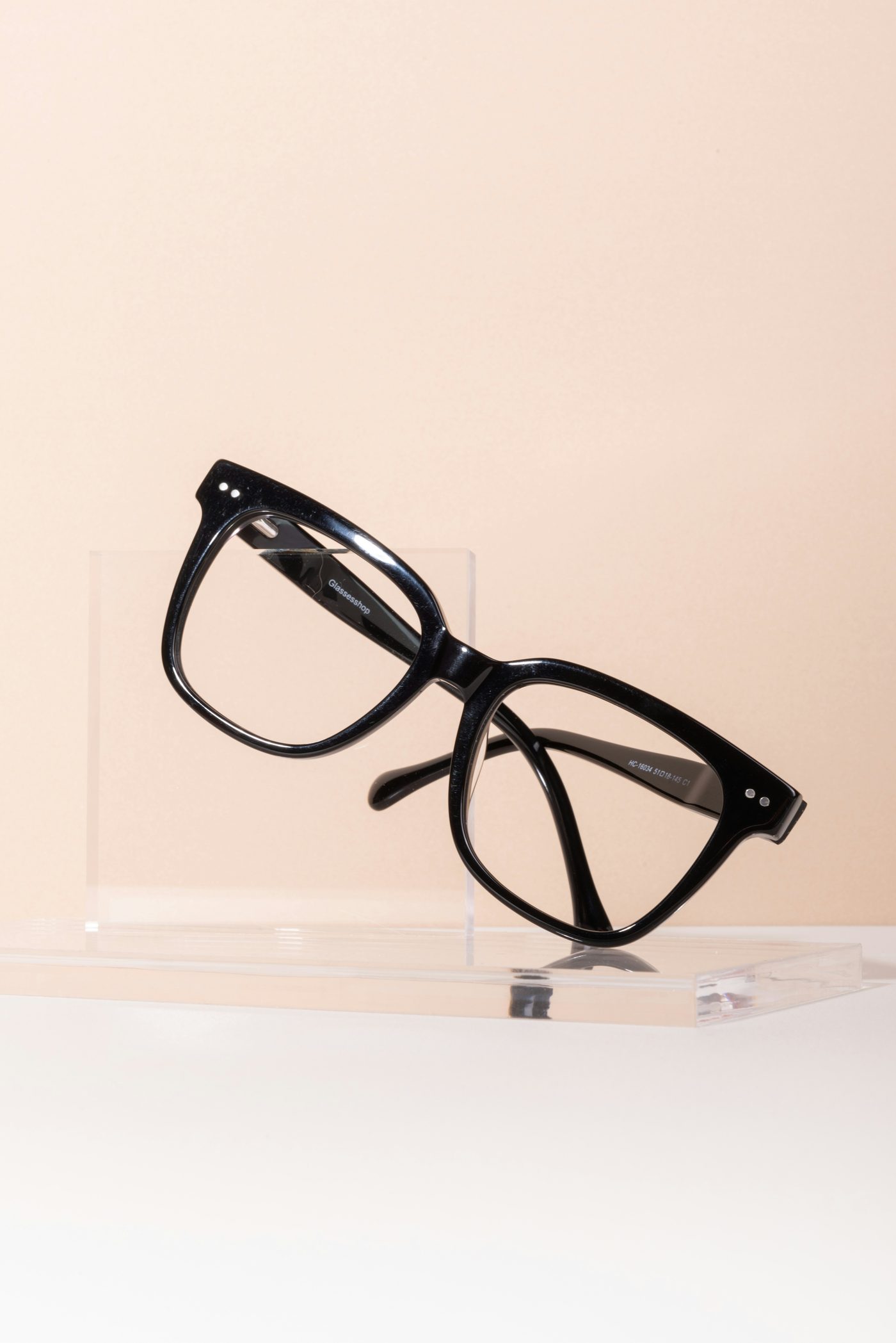 Black cat-eye glasses on a display stand